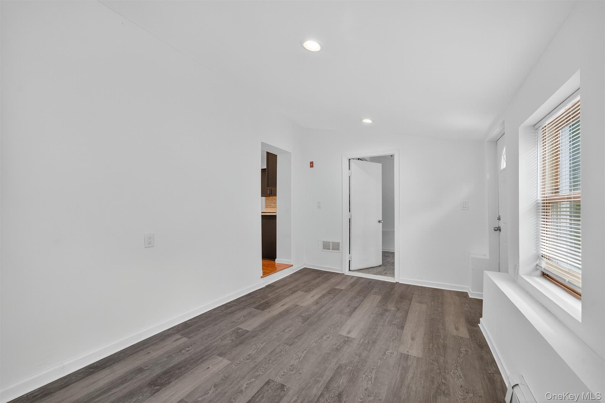 85 Holloran Road New Windsor, NY 12553 - Photo 11 of 22 a view of an empty room with wooden floor and a window