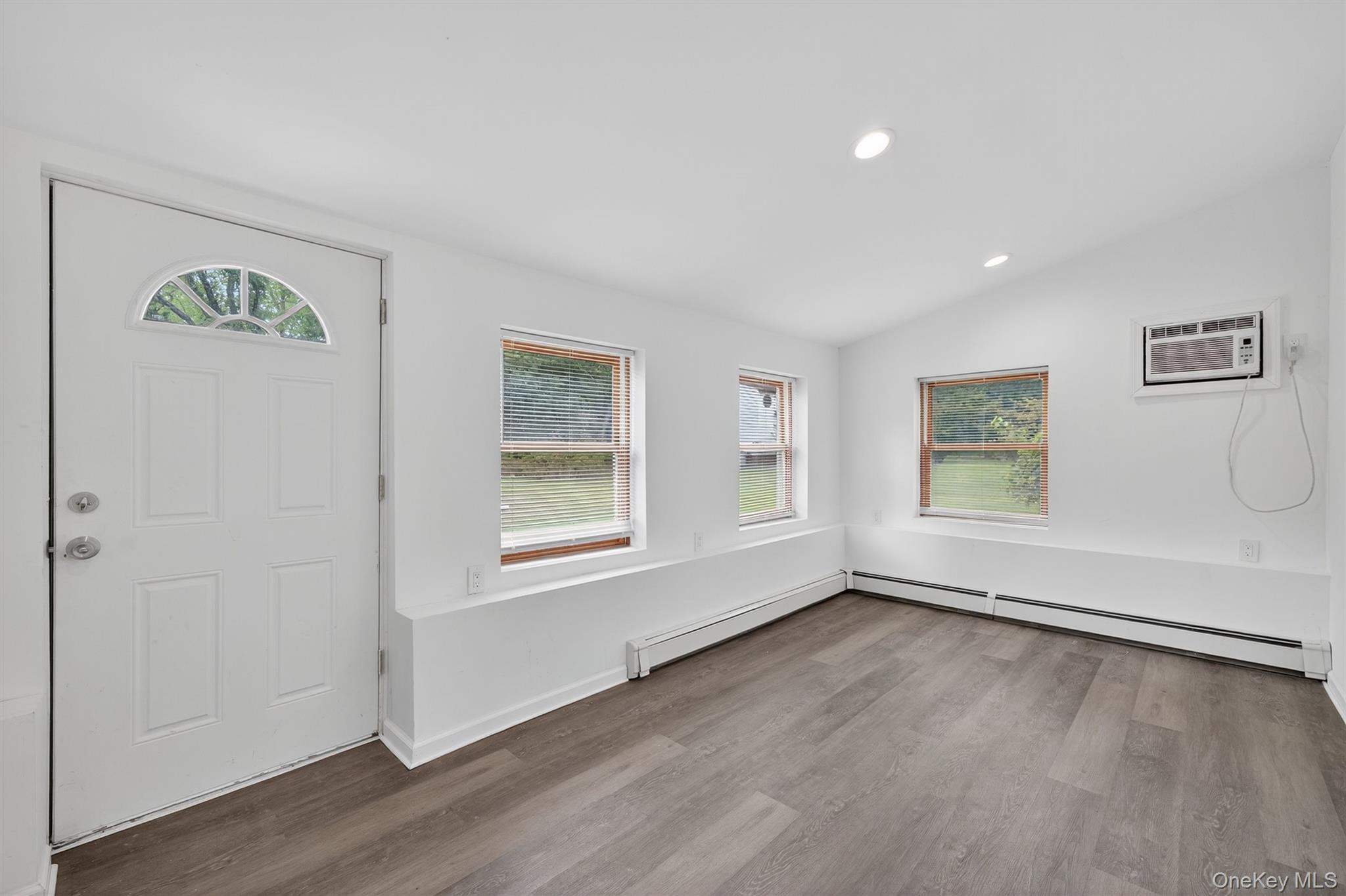 85 Holloran Road New Windsor, NY 12553 - Photo 14 of 22 an empty room with wooden floor and windows