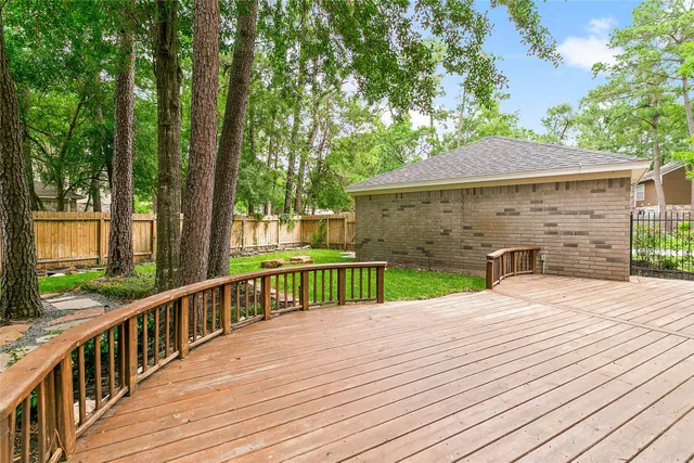 a view of a wooden deck and trees