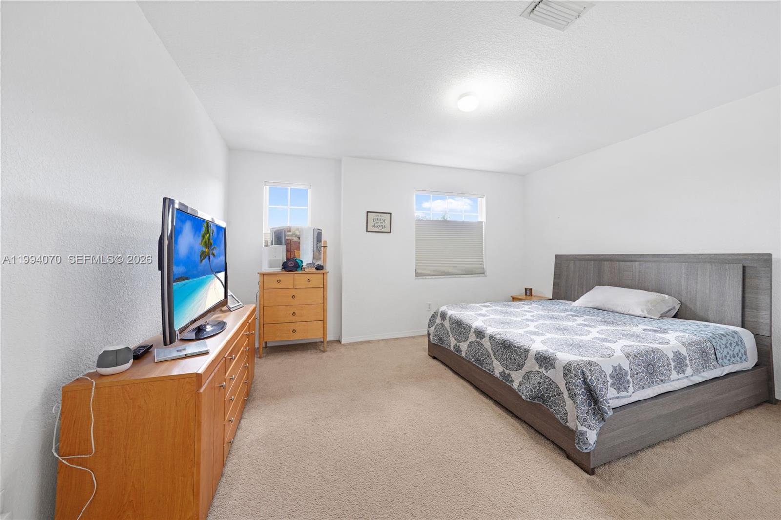 12763 Southwest 50th Street Miramar, FL 33027 - Photo 18 of 38 a bedroom with a bed and a flat screen tv