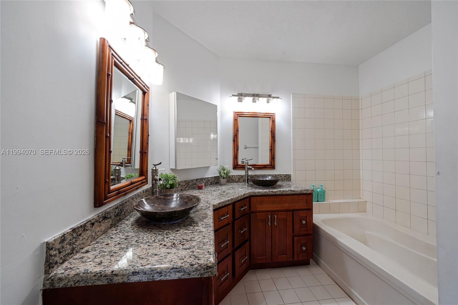 12763 Southwest 50th Street Miramar, FL 33027 - Photo 20 of 38 a bathroom with a granite countertop sink and a bathtub