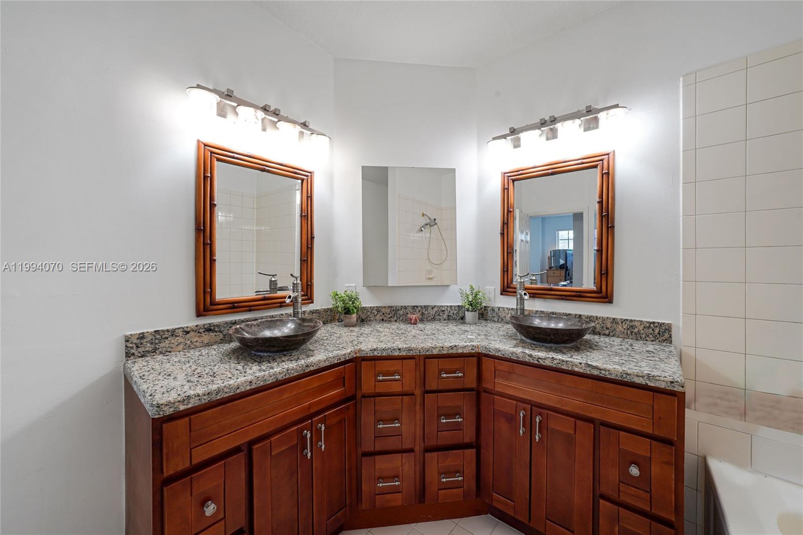 12763 Southwest 50th Street Miramar, FL 33027 - Photo 21 of 38 a bathroom with a granite countertop sink and a mirror