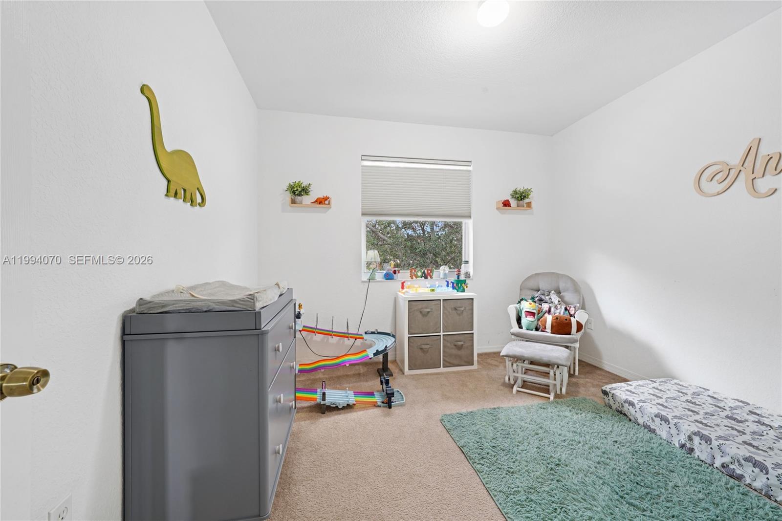 12763 Southwest 50th Street Miramar, FL 33027 - Photo 23 of 38 a living room with furniture and a window