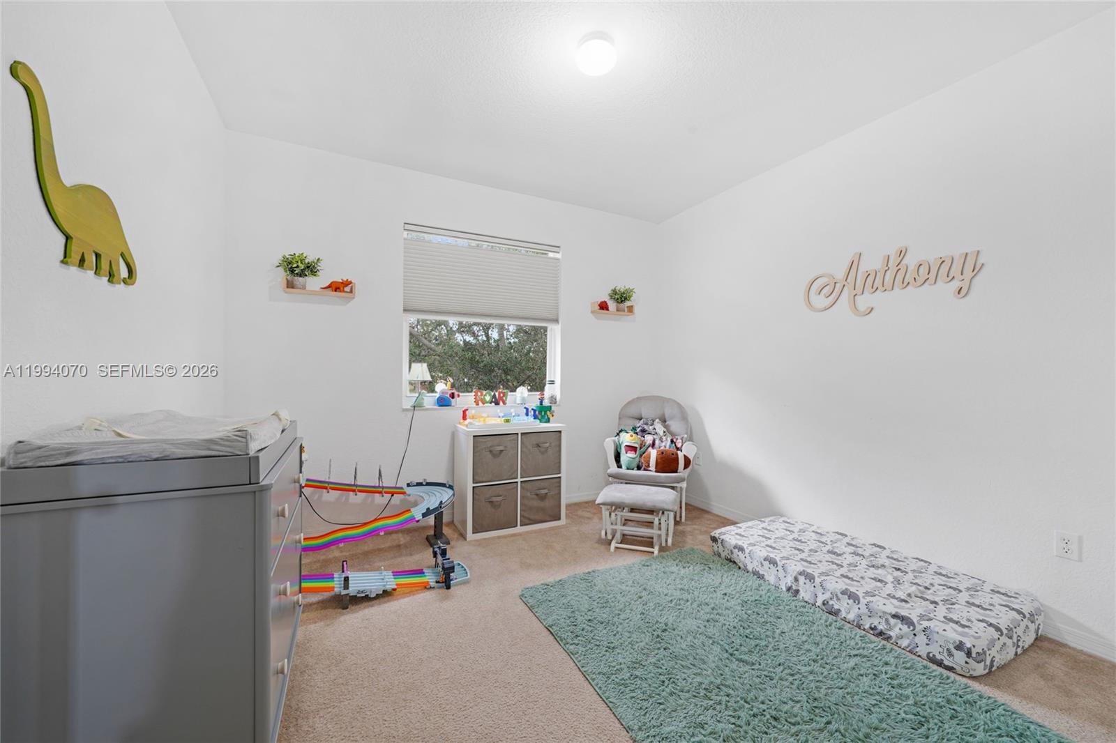 12763 Southwest 50th Street Miramar, FL 33027 - Photo 24 of 38 a living room with furniture and a window