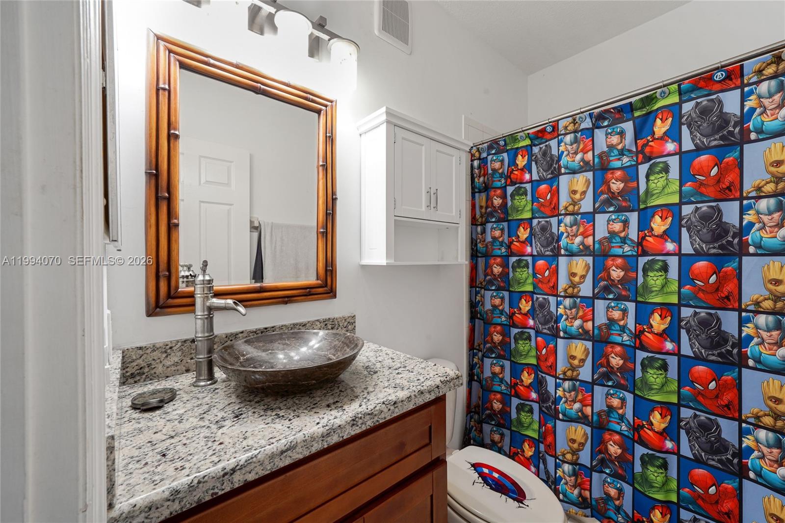 12763 Southwest 50th Street Miramar, FL 33027 - Photo 26 of 38 a bathroom with a granite countertop sink and a mirror