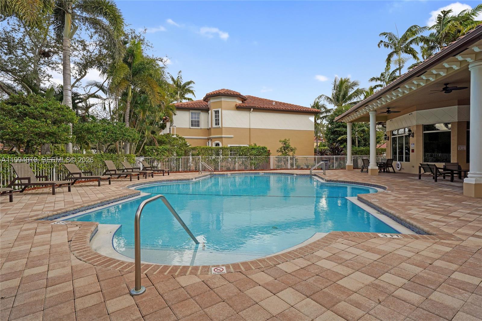 12763 Southwest 50th Street Miramar, FL 33027 - Photo 35 of 38 a swimming pool with outdoor seating