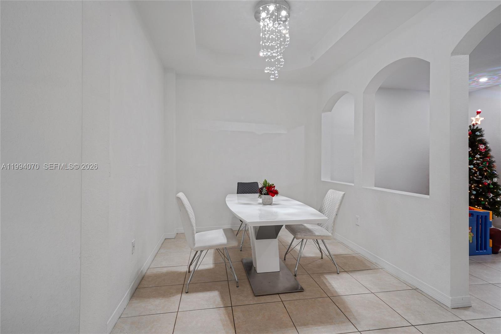 12763 Southwest 50th Street Miramar, FL 33027 - Photo 5 of 38 a room with furniture and a chandelier