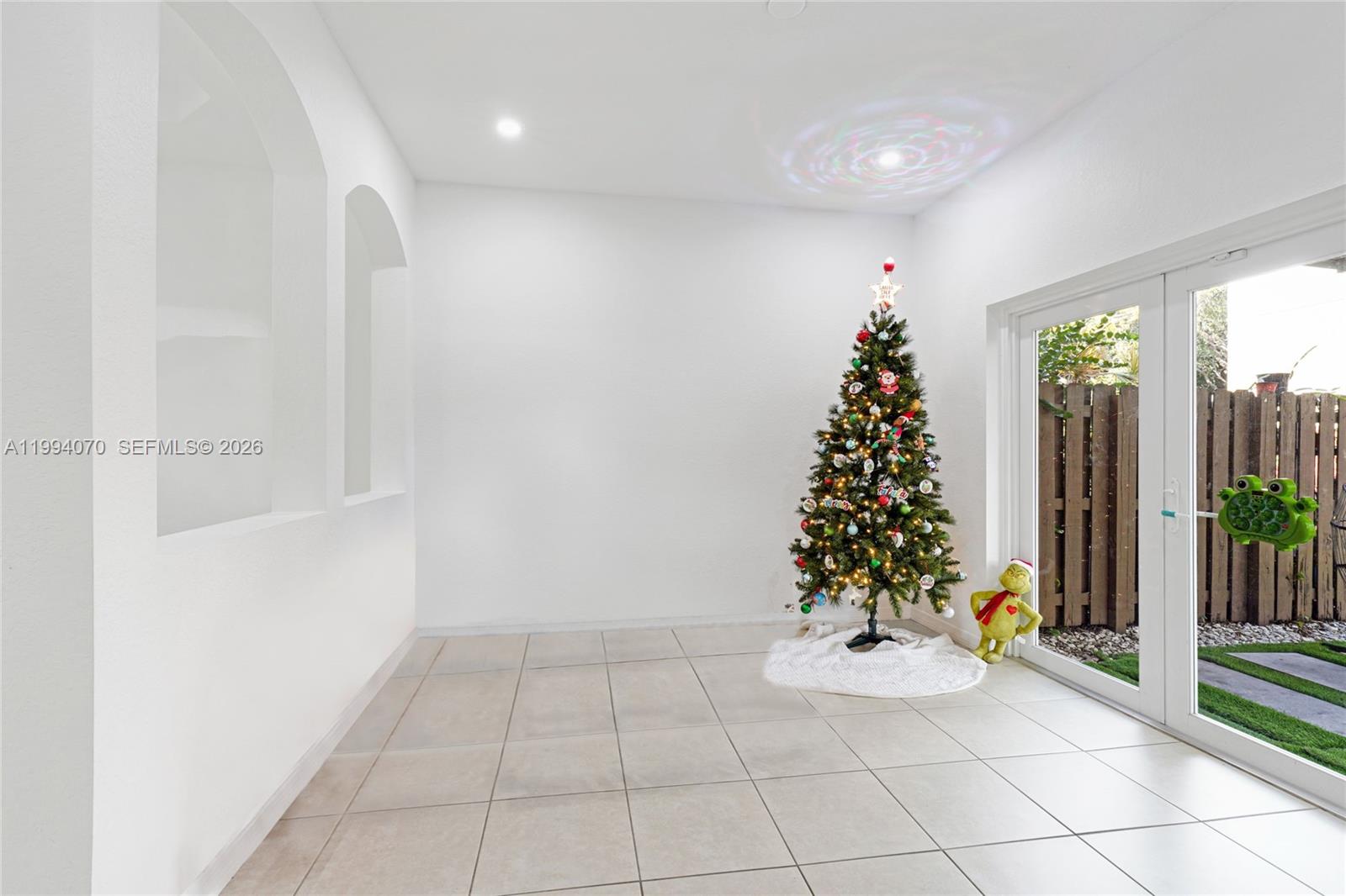 12763 Southwest 50th Street Miramar, FL 33027 - Photo 6 of 38 wooden floor in an empty room with a window