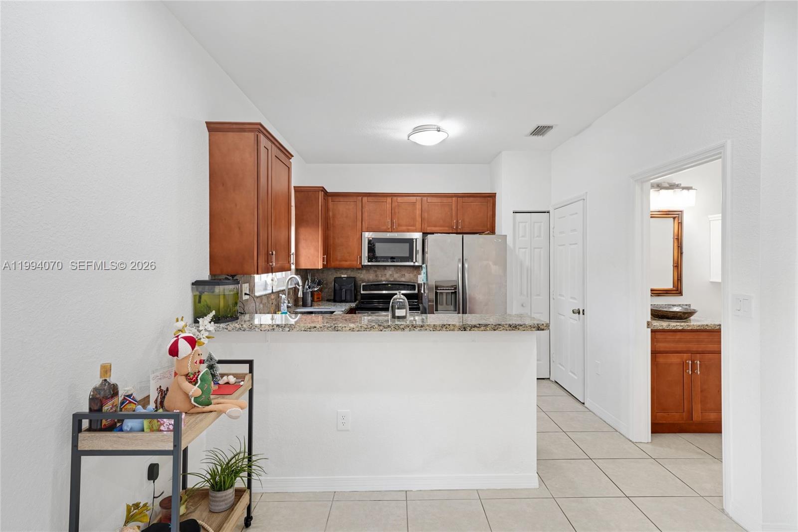 12763 Southwest 50th Street Miramar, FL 33027 - Photo 8 of 38 a kitchen with a refrigerator and a sink