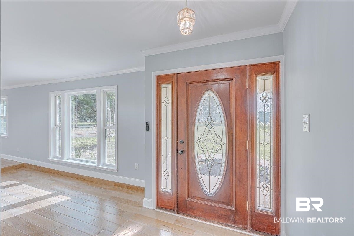 440 Dykes Road Mobile, AL 36608 - Photo 4 of 49 Entrance foyer with light wood finished floors, baseboards, and ornamental molding