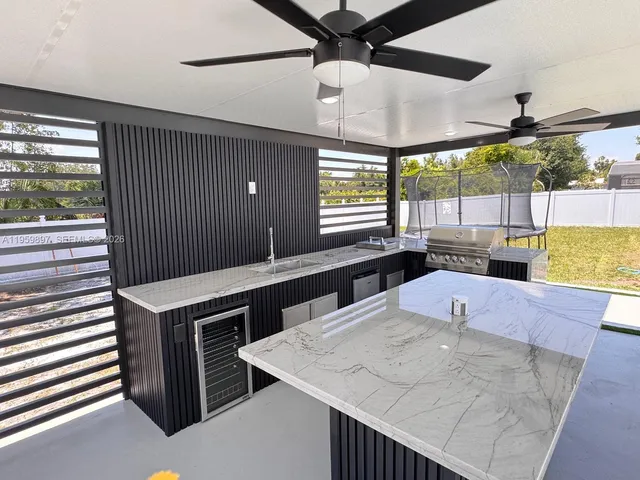 a kitchen with stainless steel appliances kitchen island a large island in the middle