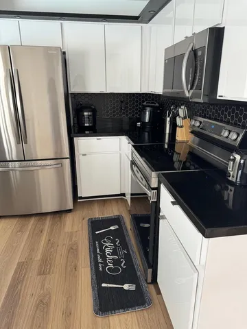 a kitchen with a refrigerator and a stove