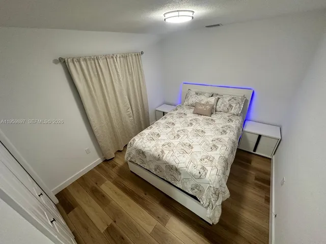 a bed sitting in a bedroom next to a window