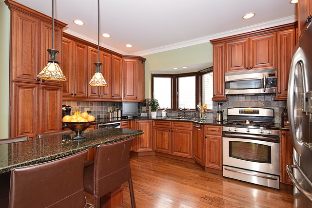 260 Addison Road Riverside, IL 60546 - Photo 7 of 25 a kitchen with stainless steel appliances a stove a sink dishwasher and cabinets with wooden floor