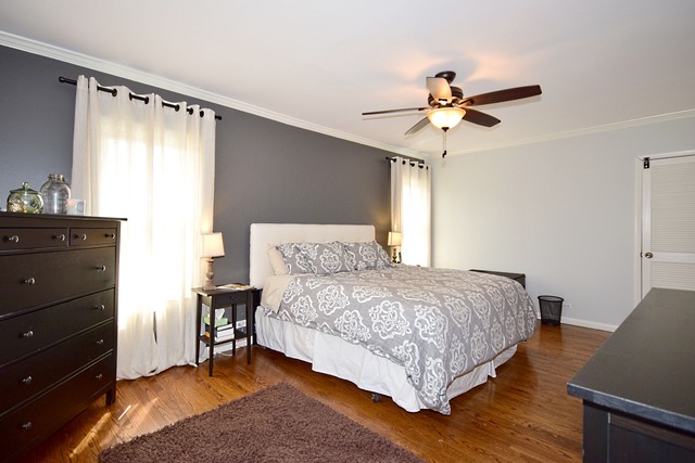 260 Addison Road Riverside, IL 60546 - Photo 9 of 25 a bedroom with a bed and a chandelier