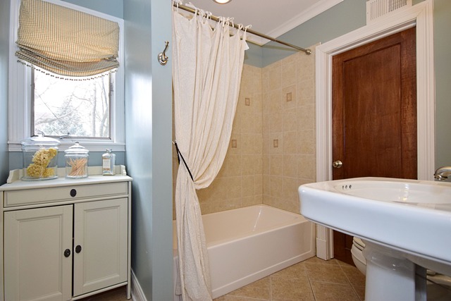 260 Addison Road Riverside, IL 60546 - Photo 10 of 25 a bathroom with a sink a bathtub and a shower