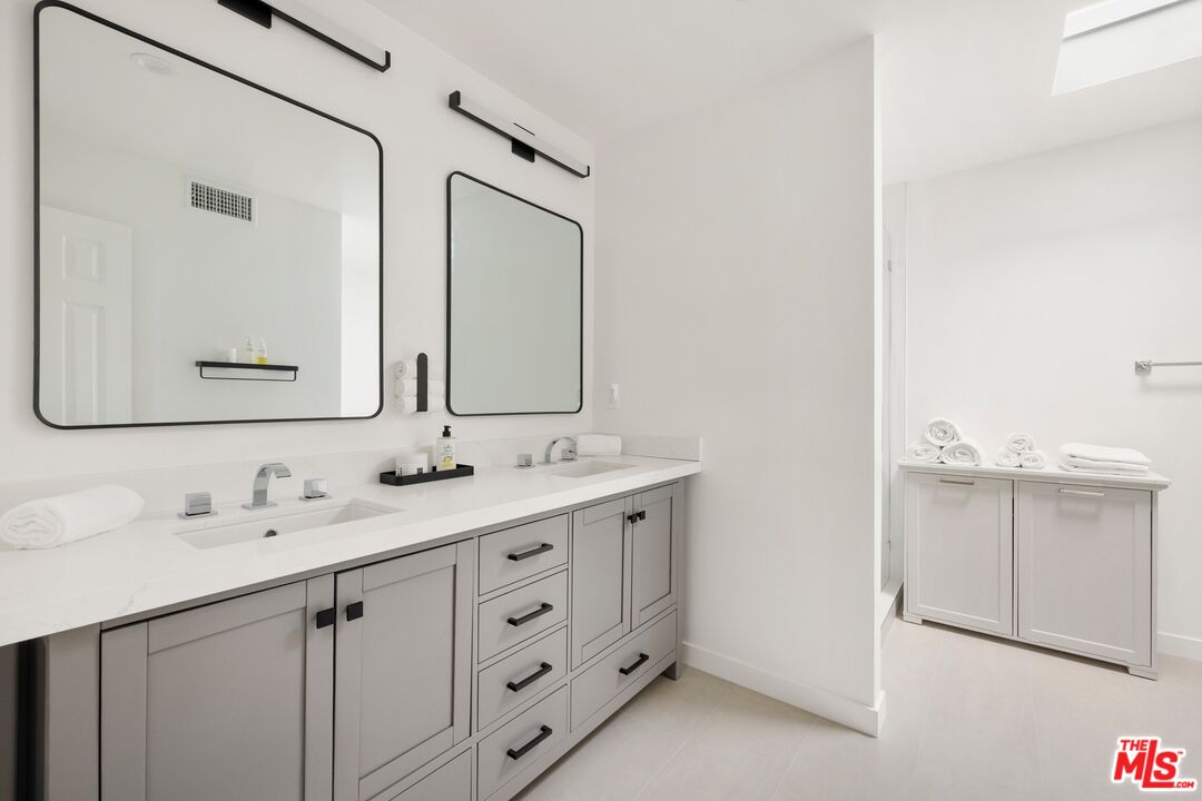1244 Stradella Road Los Angeles, CA 90077 - Photo 14 of 31 a bathroom with a double vanity sink mirror and