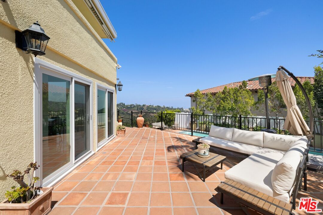 1244 Stradella Road Los Angeles, CA 90077 - Photo 21 of 31 a outdoor space with patio the couch and dining table with garden view