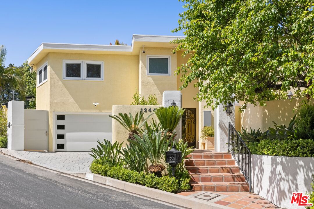 1244 Stradella Road Los Angeles, CA 90077 - Photo 25 of 31 a front view of a house with potted plants