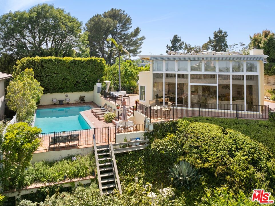 1244 Stradella Road Los Angeles, CA 90077 - Photo 27 of 31 a view of a house with backyard sitting area and garden