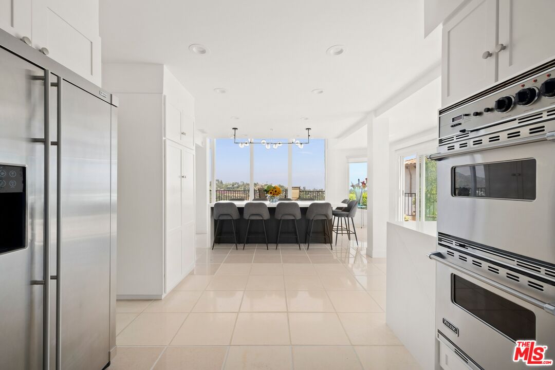 1244 Stradella Road Los Angeles, CA 90077 - Photo 7 of 31 a kitchen with furniture and a stove