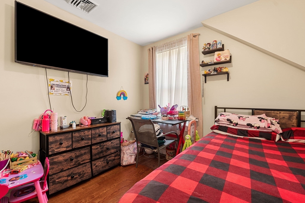 883 Grinnell Street Fall River, MA 02721 - Photo 13 of 41 a bed room with furniture and a flat screen tv