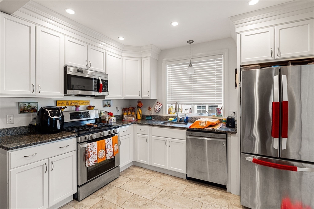 883 Grinnell Street Fall River, MA 02721 - Photo 14 of 41 a kitchen with stainless steel appliances granite countertop a refrigerator and a stove top oven