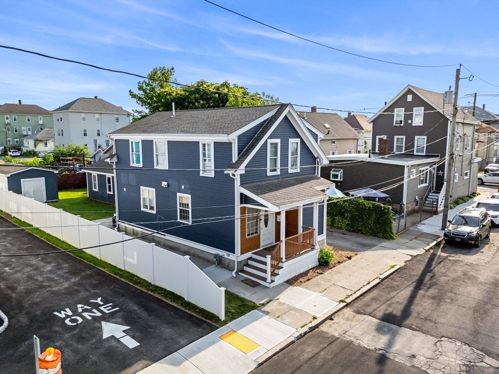 883 Grinnell Street Fall River, MA 02721 - Photo 2 of 41 a front view of a house with a garden