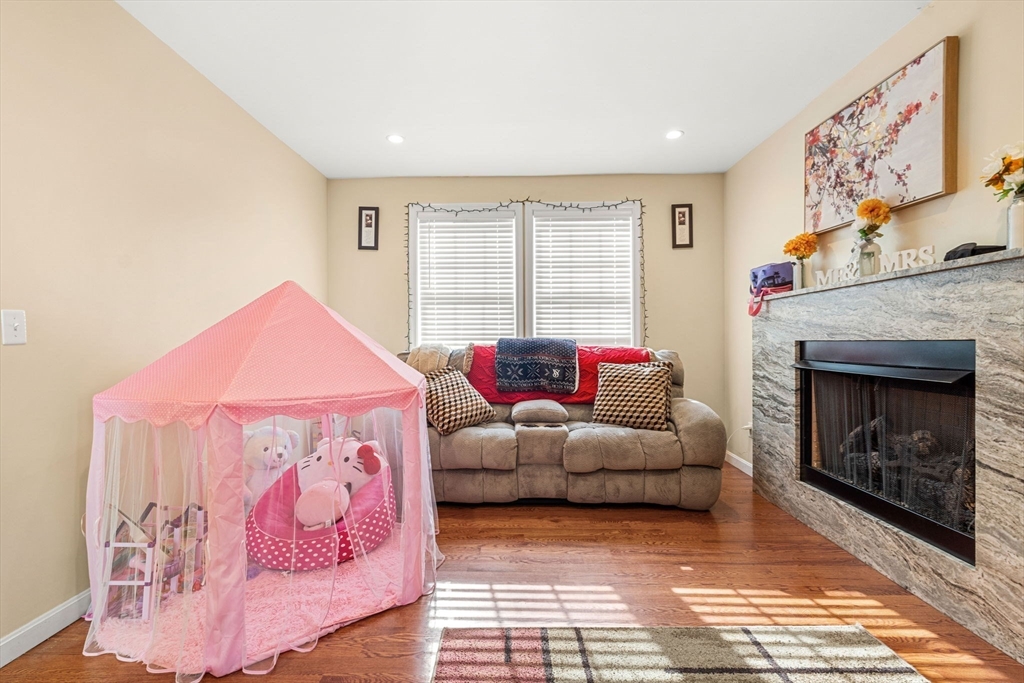 883 Grinnell Street Fall River, MA 02721 - Photo 23 of 41 a living room with furniture and a fireplace