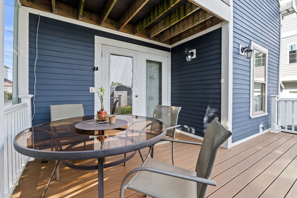 883 Grinnell Street Fall River, MA 02721 - Photo 28 of 41 a view of a deck with table and chairs and potted plants