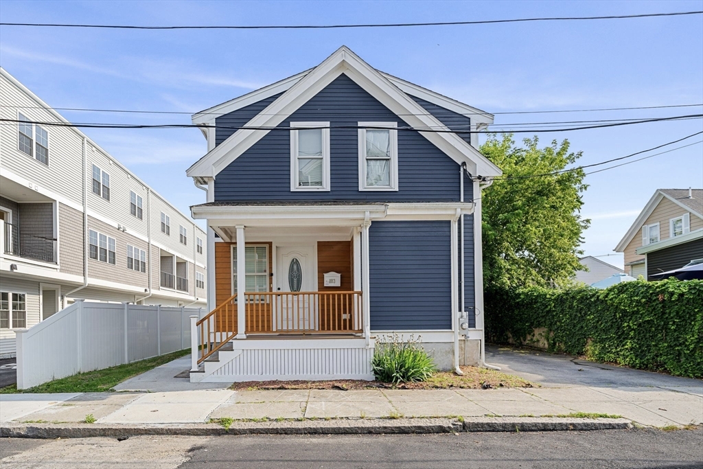883 Grinnell Street Fall River, MA 02721 - Photo 3 of 41 a front view of a house with a yard and garage