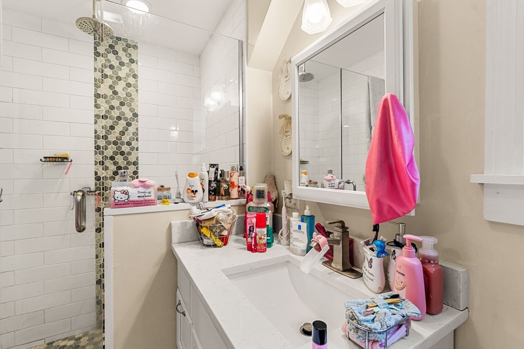 883 Grinnell Street Fall River, MA 02721 - Photo 9 of 41 a bathroom with a sink and a mirror
