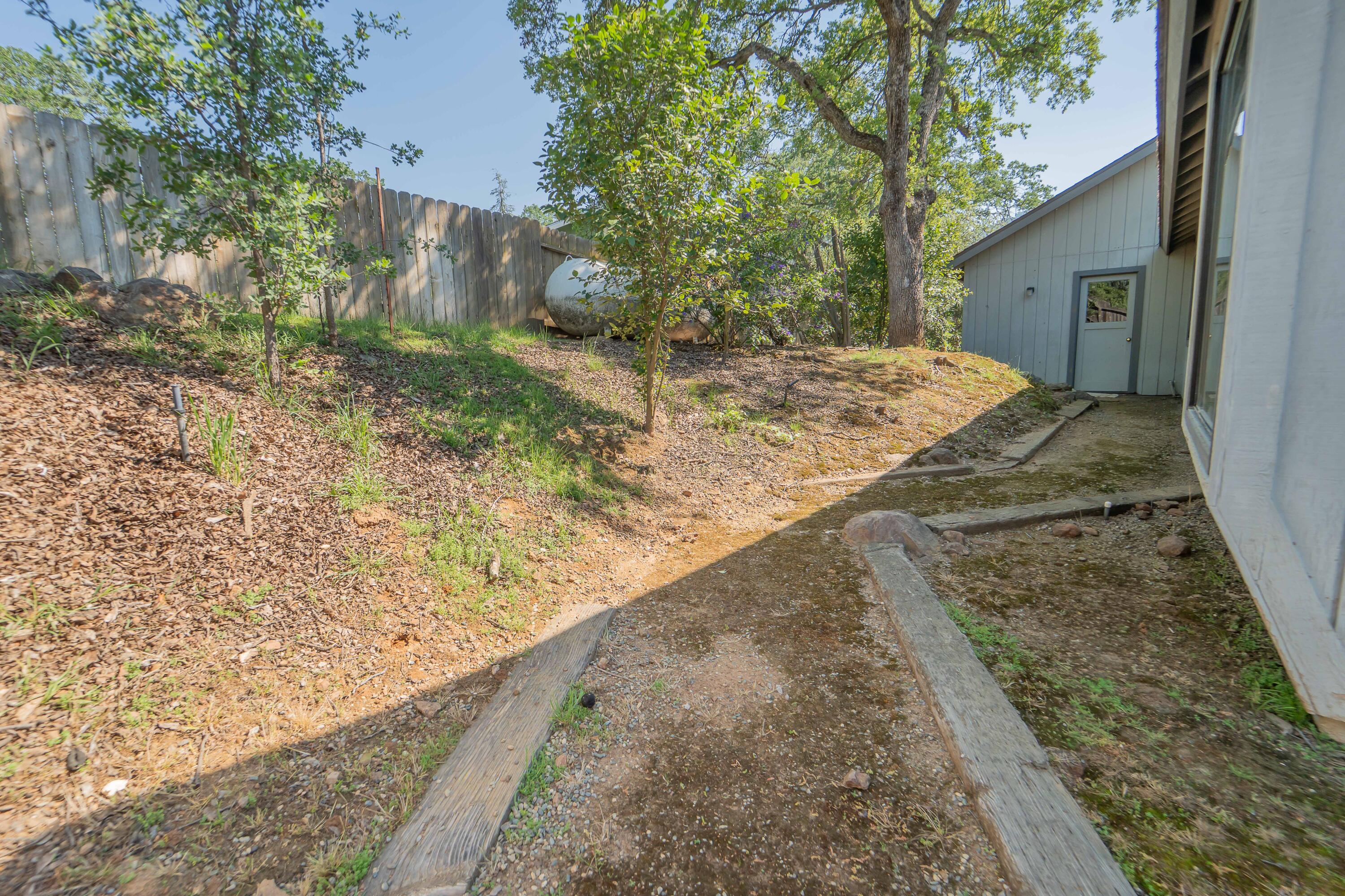 40962 Oak Ridge Drive Three Rivers, CA 93271 - Photo 32 of 36 a view of a backyard with wooden fence