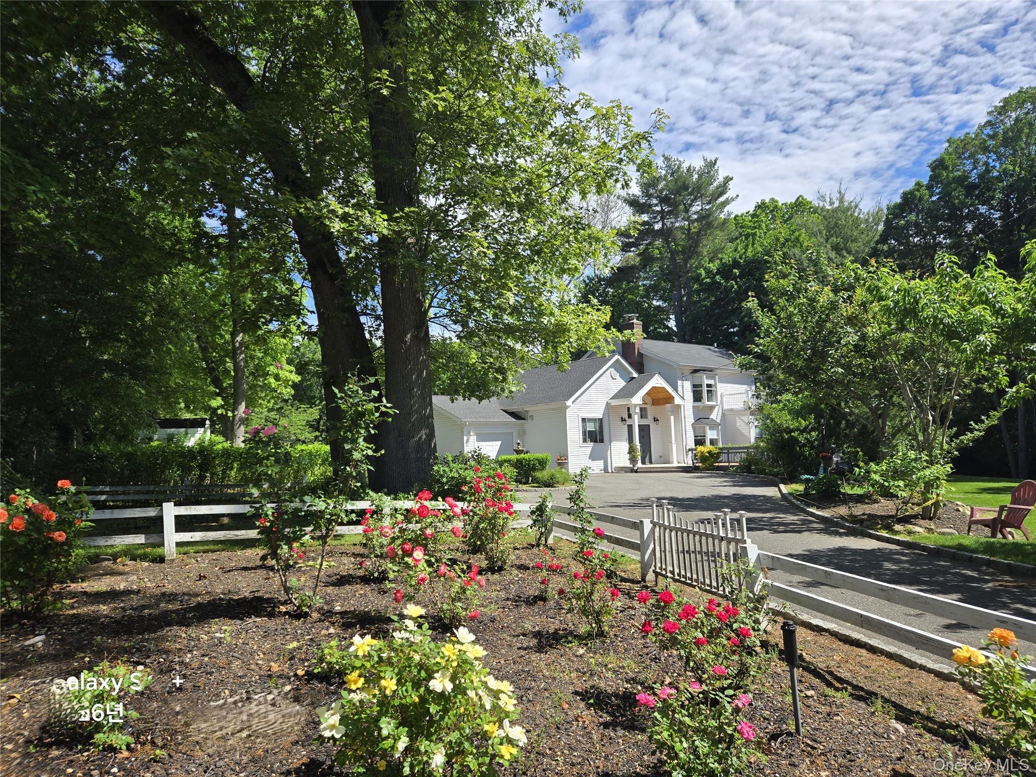 249 Cold Spring Road Syosset, NY 11791 - Photo 2 of 28 a front view of a house with a yard