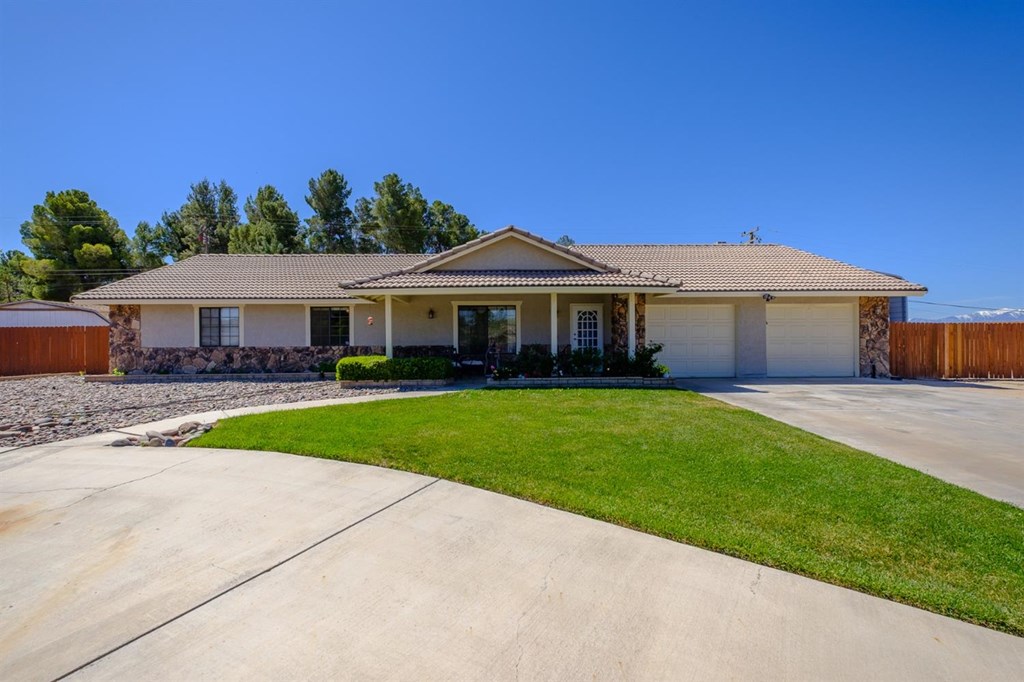18523 Cocqui Road Apple Valley, CA 92307 - Photo 1 of 1 a front view of a house with a yard