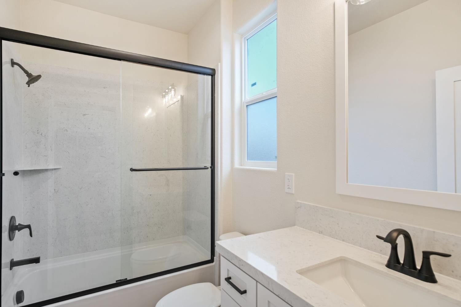 243 East 3rd Street Tracy, CA 95376 - Photo 12 of 29 a bathroom with a shower and a sink