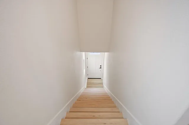 a view of a hallway with wooden floor