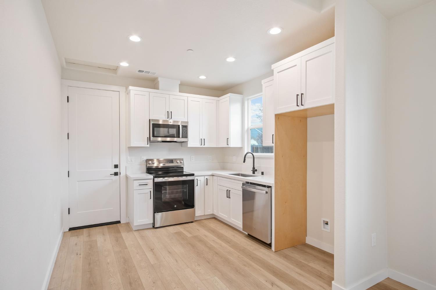 243 East 3rd Street Tracy, CA 95376 - Photo 27 of 29 a kitchen with stainless steel appliances granite countertop a refrigerator and a stove top oven