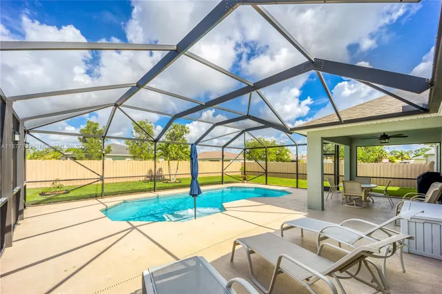 a view of a dining room with a table and chairs