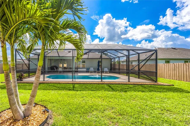 a view of a house with swimming pool and porch