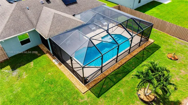 an aerial view of a house with backyard