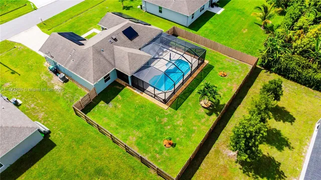 an aerial view of a pool patio deck and outdoor seating