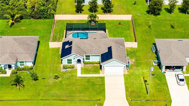 an aerial view of a house with a swimming pool
