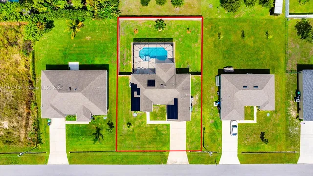 an aerial view of a house with a yard