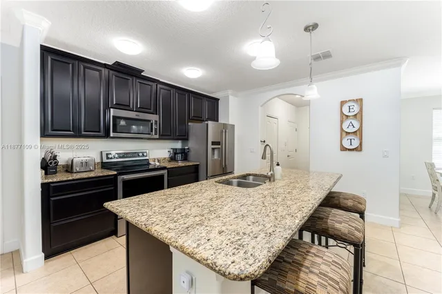a kitchen with granite countertop stainless steel appliances and wooden cabinets