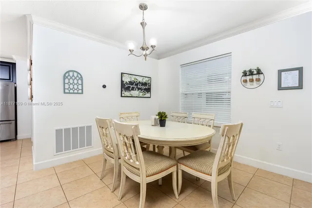a view of a dining room with furniture and a chandelier