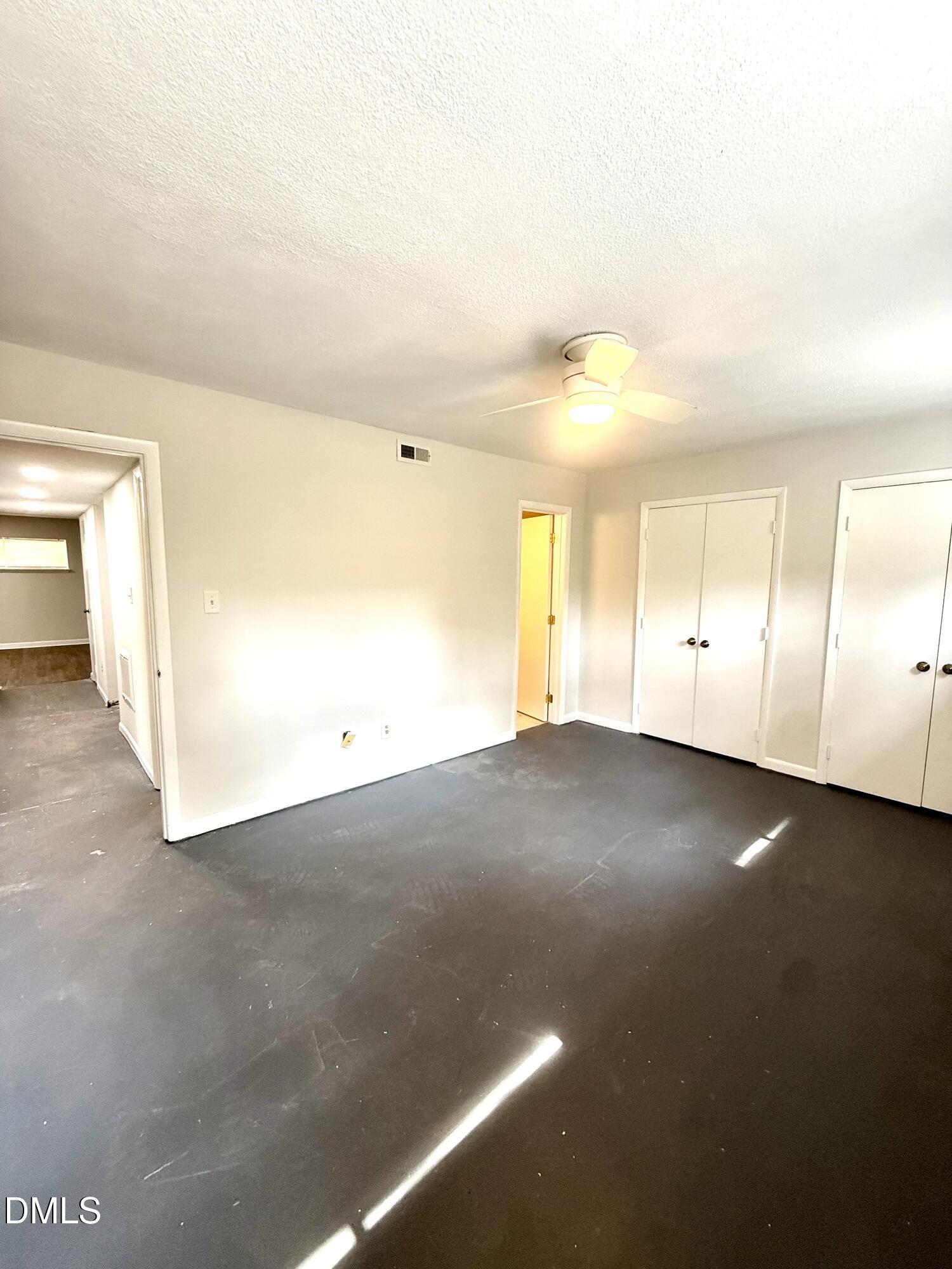 546 Pine Ridge Place Raleigh, NC 27609 - Photo 13 of 28 an empty room with a empty space and windows