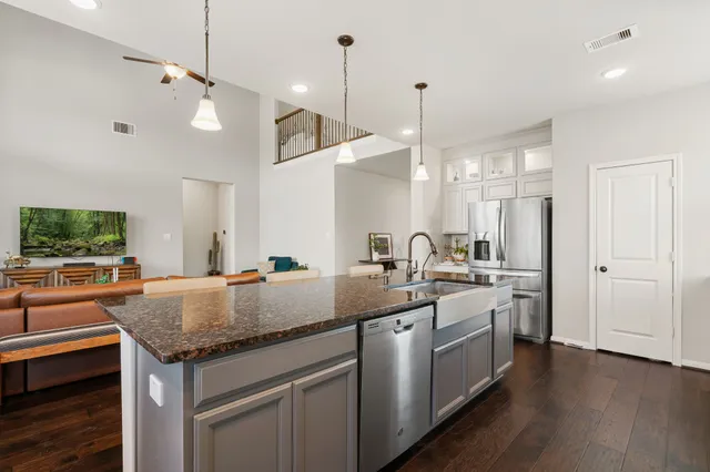 a kitchen with sink stove and refrigerator