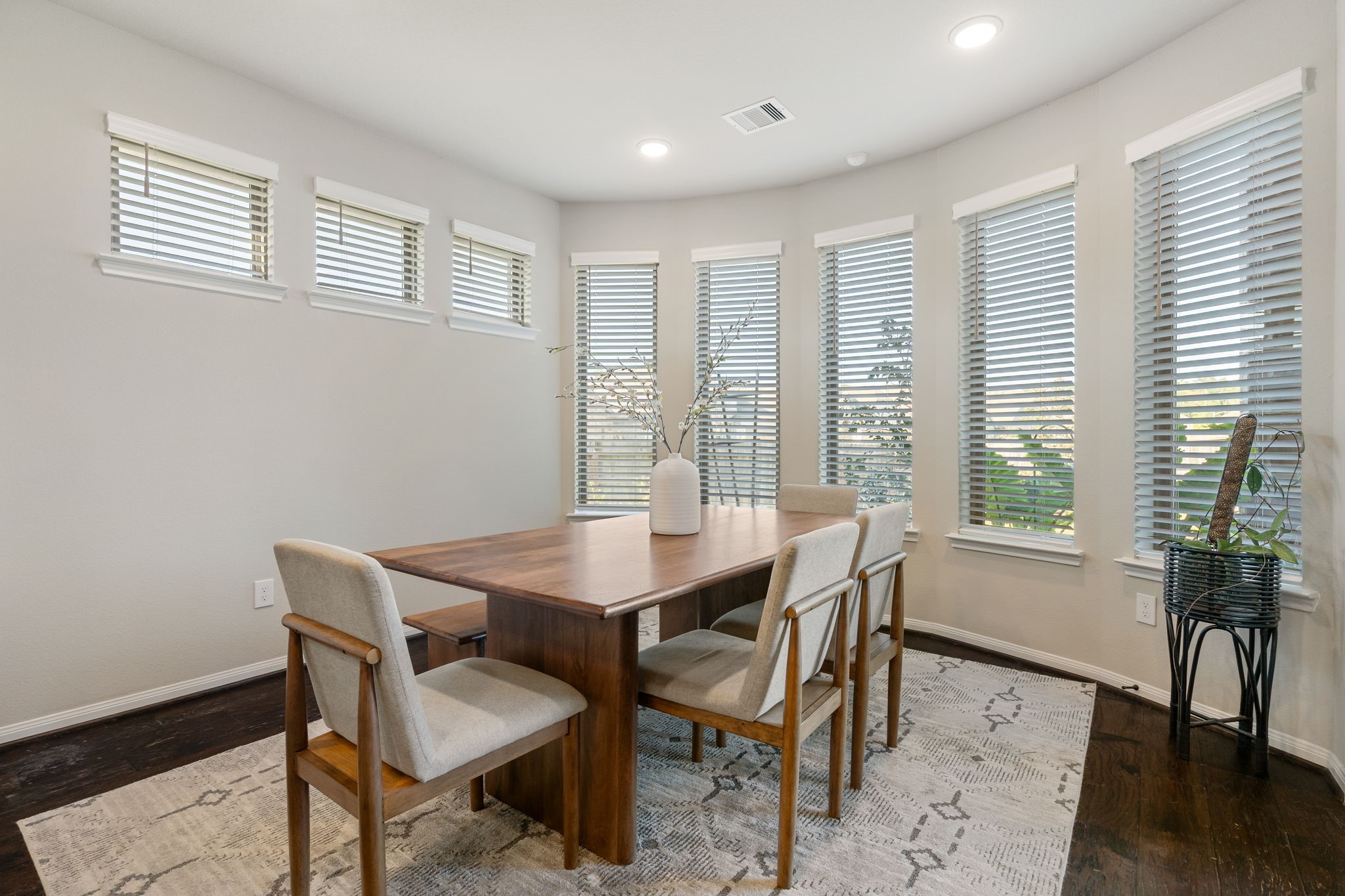 17525 Sunset Skies Road Conroe, TX 77302 - Photo 17 of 50 The Dining Room features warm wood floors, a curved accent wall and large windows.