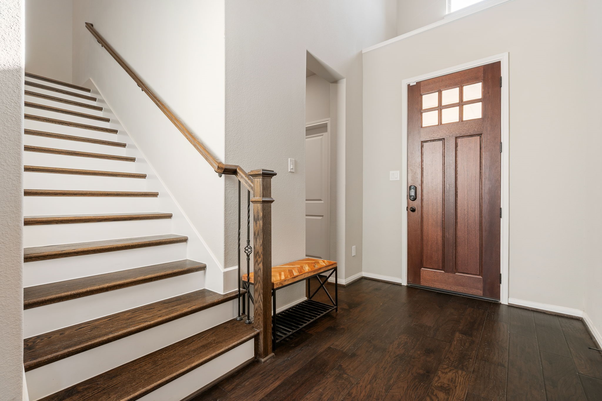 17525 Sunset Skies Road Conroe, TX 77302 - Photo 30 of 50 Wide Staircase with Upgraded Wood Stairs and Spindles. The hearty 8' Red Oak stained Mahogany Crafstman Door completes the picture!